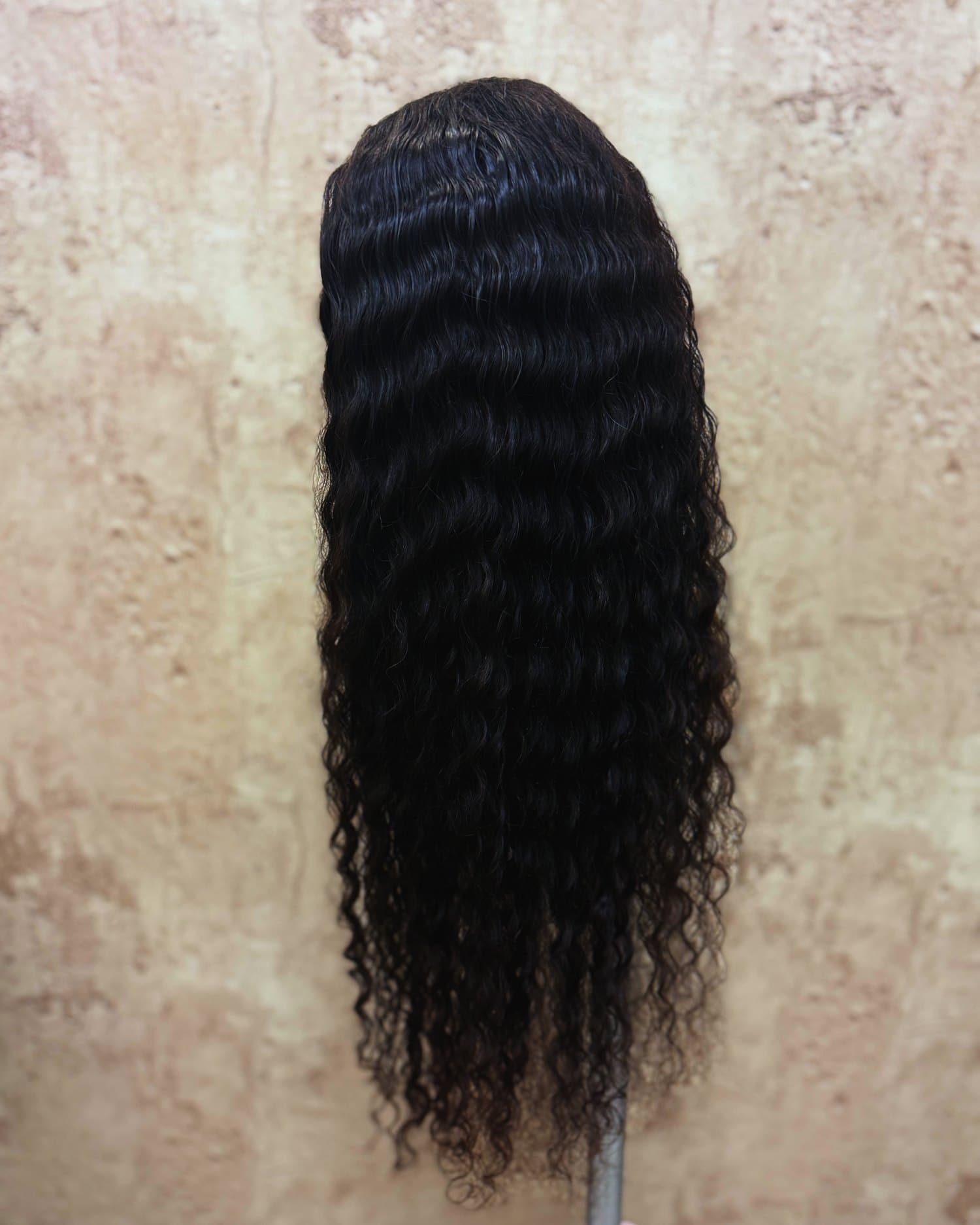 The black deep-wave unit from behind, curl pattern running the full length.